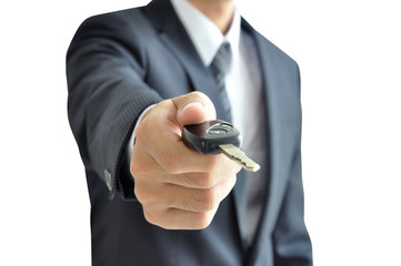 Businessman hand holding a car key on white background