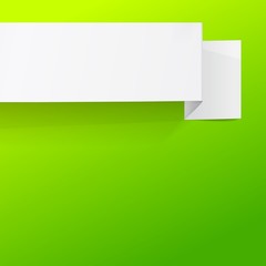 White sheet of paper on a green background. Origami banner.