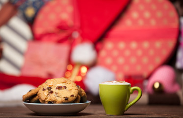 Cookie and cup of coffee on christmas background.