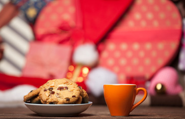 Cookie and cup of coffee on christmas background.