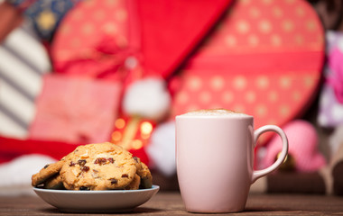 Cookie and cup of coffee on christmas background.