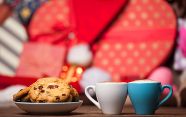two cup of coffee and croissant on christmas background.