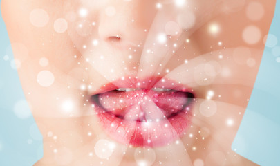 Pretty woman lips blowing abstract white lights