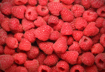 background of ripe juicy raspberries