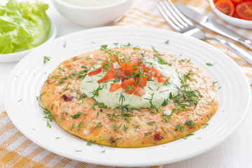 dietary omelette with carrot and green yogurt sauce on a plate