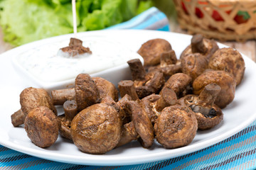 fried mushrooms with yogurt sauce on a plate