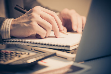 Businessman analyzing investment charts with laptop. Accounting