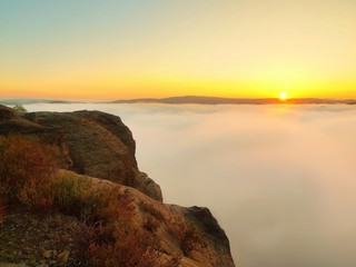Fototapeta premium Magnificent fogy landscape, gentle pink misty sunrise in a rocks