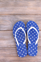 Color flip-flops on wooden background