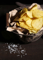 Tasty potato chips in metal basket