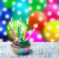Birthday cupcake with burning candles