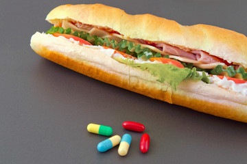 Pills and two hot dogs with various ingredients