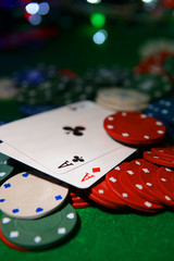 Cards and chips for poker on shiny background