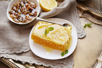 Fresh honey snack on tray on wooden table