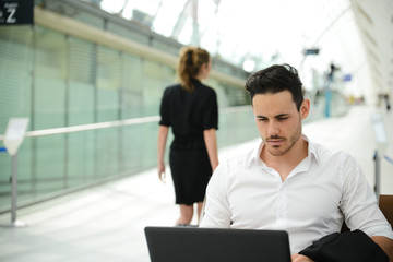 handsome businessman public station working computer wifi area