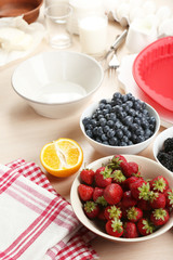 Baking tasty pie and ingredients for it on table in kitchen