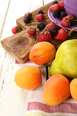 Ripe fruits and berries on table close up