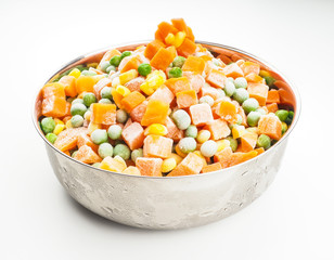 Frozen vegetables, carrots, peas and maize in steel bowl
