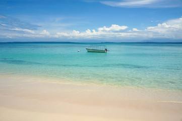 Obraz na płótnie Canvas Tropical beach with boat on mooring buoy
