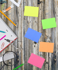 School supplies on wooden table, close-up.