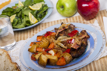  baked meat with potatoes, and watercress salad.