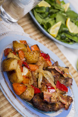  baked meat with potatoes, and watercress salad.
