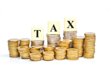 Paying tax - a pile of coins with the word tax