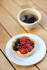 Custard fruit tart and cup of coffee