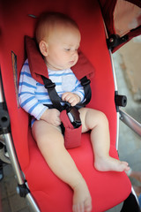 Little baby boy in a stroller