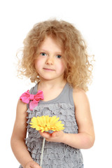 Little girl holding bunch of flowers.