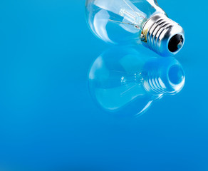 Light bulb isolated on blue glossy