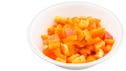 Chopped orange capsicums in white bowls over white background