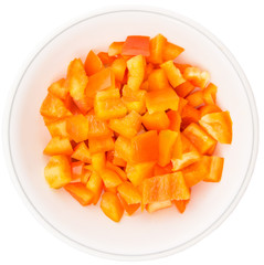 Chopped orange capsicums in white bowls over white background