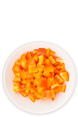 Chopped orange capsicums in white bowls over white background