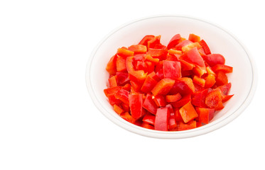 Chopped red capsicums in white bowls over white background