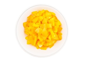Chopped yellow capsicums in white bowls over white background