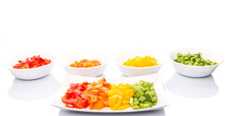 Colorful chopped capsicums in a plate and bowls