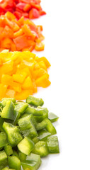 Heaps of chopped colorful capsicums over white background