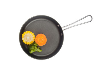 Corn, broccoli and carrot in a frying pan isolated