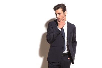 elegant business man thinking and looks away to  side