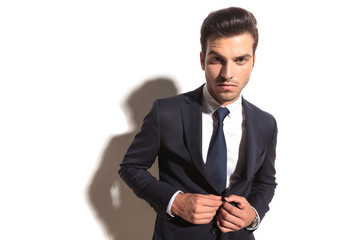 dramatic fashion business man unbottoning his coat