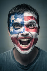 Excited man with US flag painted on face