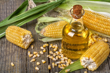 Freshly picked domestic corn with corn oil - obrazy, fototapety, plakaty