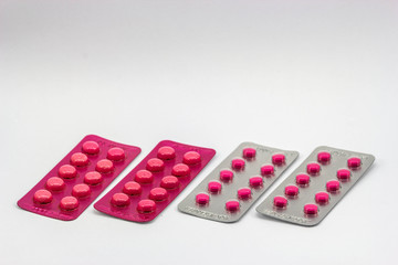 Pills packed in blister on white background