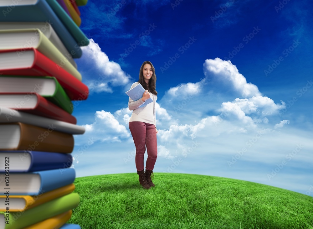 Poster Composite image of smiling student holding textbook