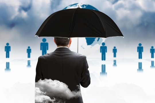 Composite image of mature businessman holding an umbrella