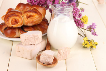 Dry yeast with pastry on wooden table close-up