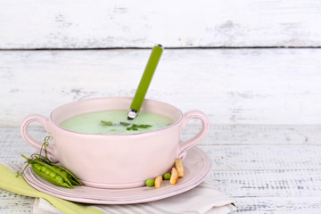 Tasty peas soup on wooden table