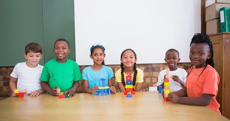 Cute pupils playing with building blocks
