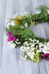 Wildflower wreath on grey wooden background